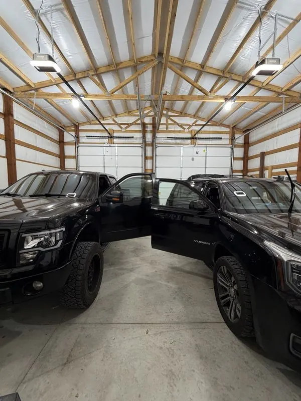 Black Ford F-150 and GMC Yukon with tinted windows