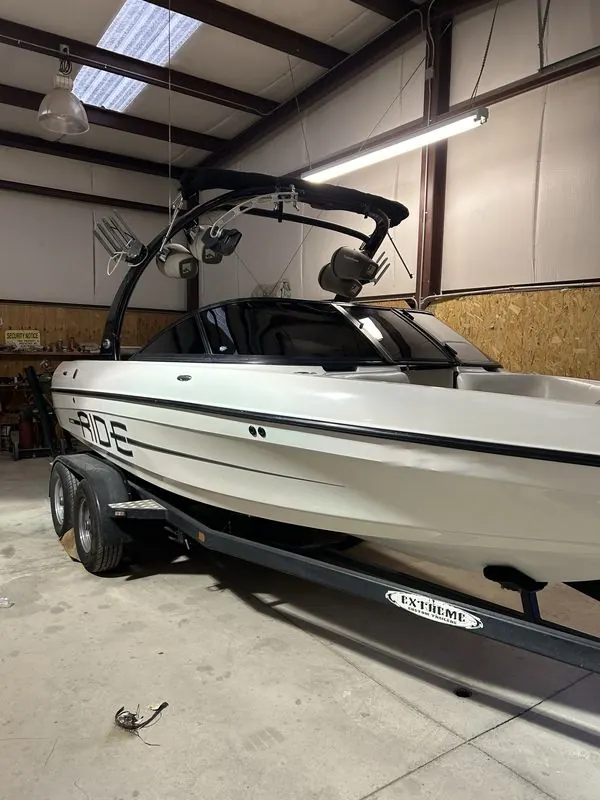 White wake boat with tinted windshield