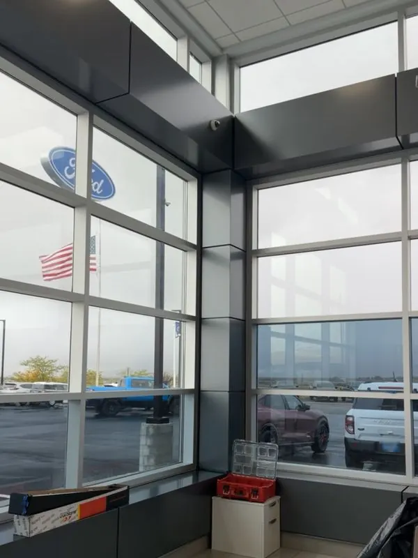 Tinted showroom windows at a car dealership