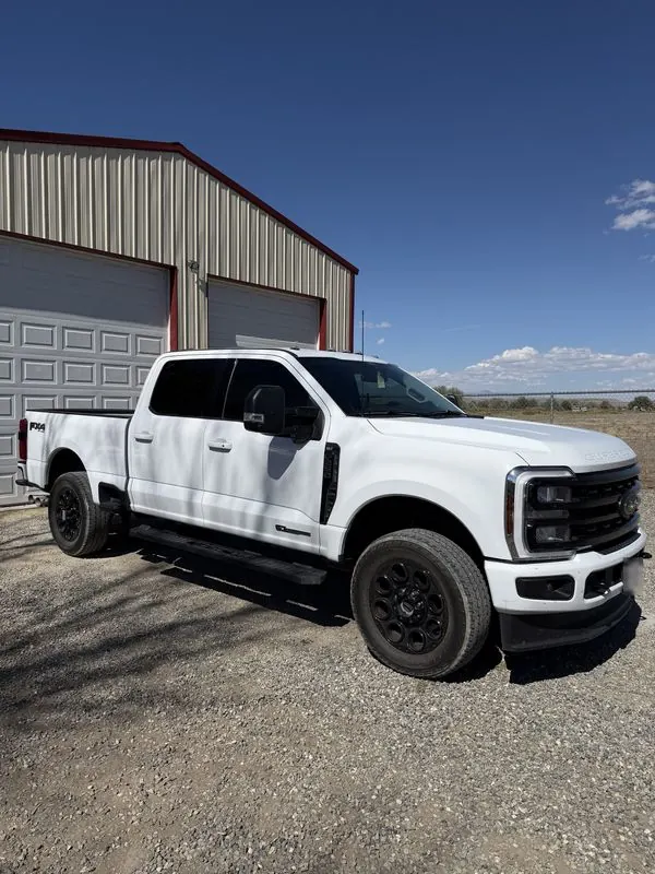 White Ford Super Duty XLT with tinted windows outside the shop