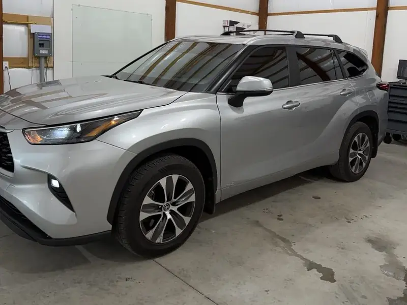 Silver Toyota Highlander with tinted windows in the V3 Tinting shop