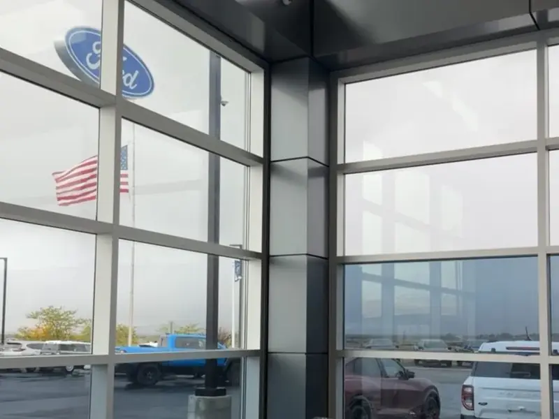 Tinted showroom windows at a car dealership